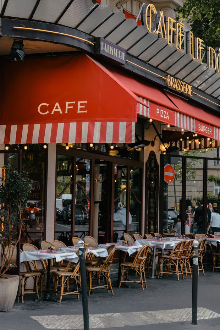 A picturesque Parisian café terrace with empty tables ready for customers.
