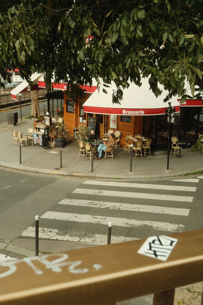 Discover a quaint Parisian brasserie captured in a quiet corner of Île-de-France. Perfect for lifestyle and travel themes.